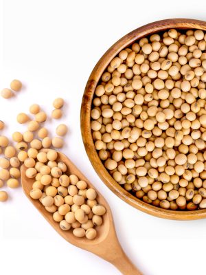 Closeup soy beans in wooden bowl  isolated on old rustic wood table background. Natural protein concept. Vintage style.